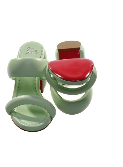 a pair of green and red sandals on a white background