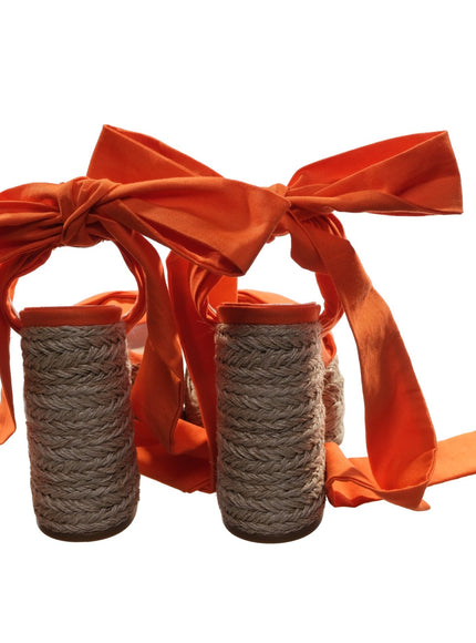 a pair of twine wrapped bottles with a ribbon tied around them