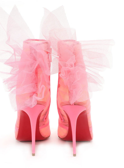 a pair of pink high heeled shoes with ruffles