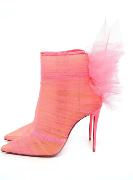 a pink high heeled shoe with a pink ruffle