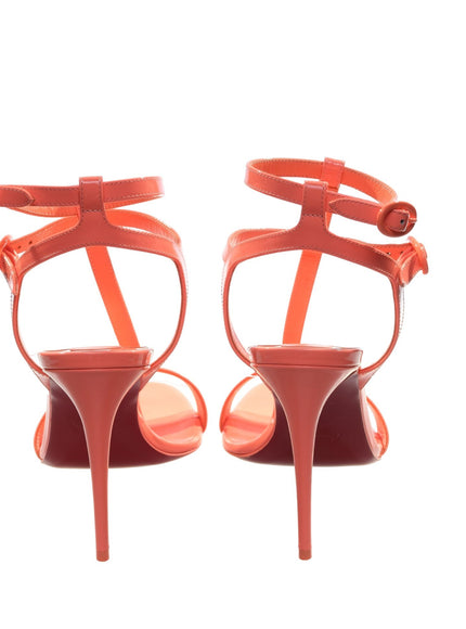 a pair of red high heeled shoes on a white background