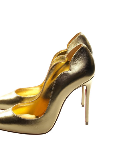 a pair of gold high heels on a white background