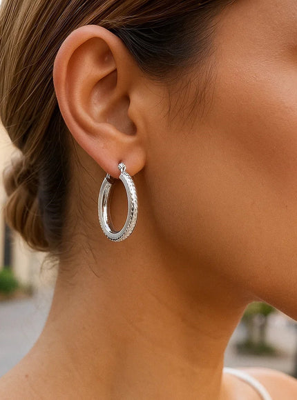 14k White Gold Diamond Cut Textured Oval Hoop Earrings.
