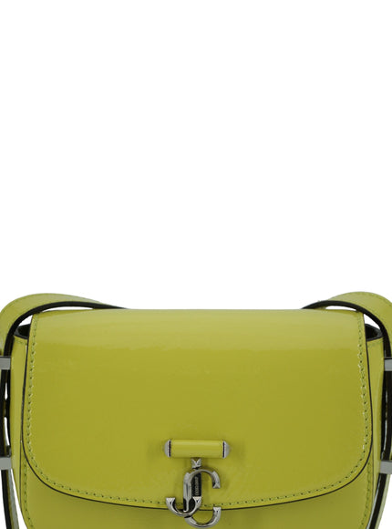 a yellow purse with a metal handle on a white background