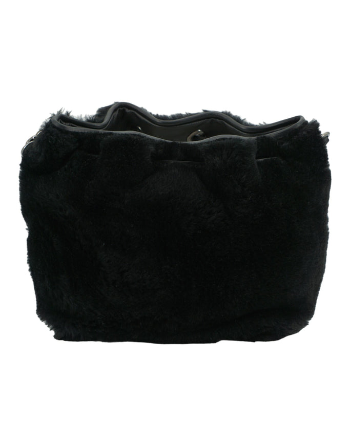 a black purse with a bow on it