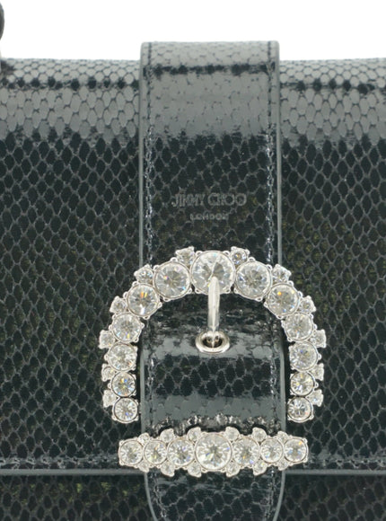 a black purse with a jeweled buckle