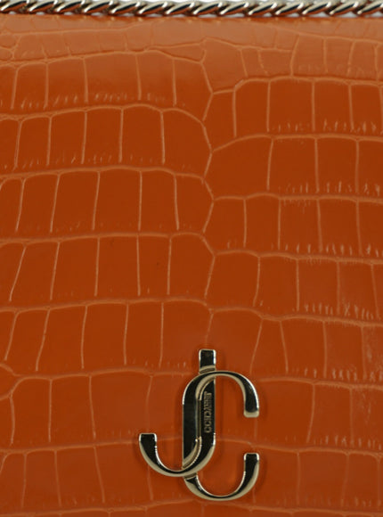 an orange purse with a silver handle