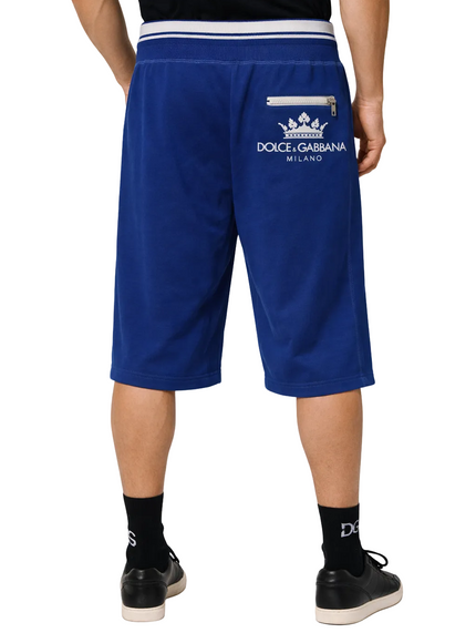 Blue shorts with Dolce & Gabbana logo worn by a person on a white background