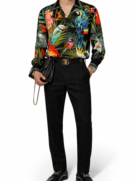 Person wearing a colorful parrot-themed shirt with black pants and shoes on a white background