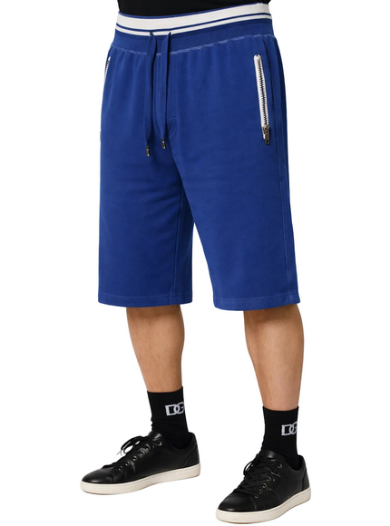 Person wearing a Dolce & Gabbana blue shorts with a white background