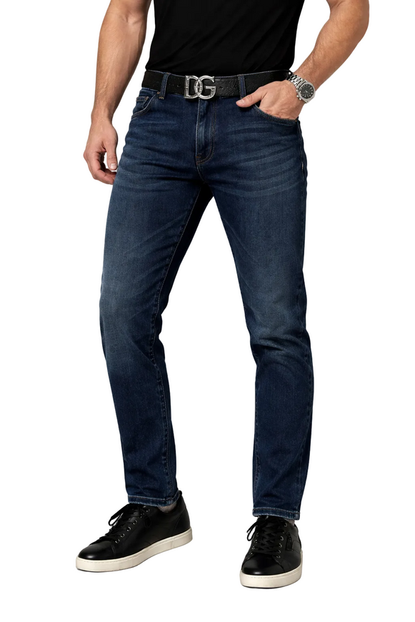 Person wearing dark blue Dolce & gabbana jeans on a white background