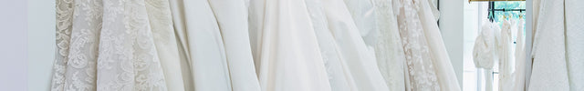Luxury designer wedding dresses hanging on racks at Ellie Belle, a designer fashion and bridal boutique in Eden Prairie, Minnesota.