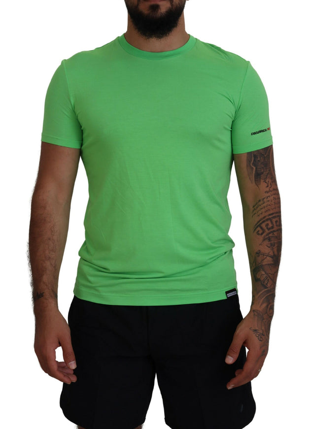 a man wearing a green shirt and black shorts