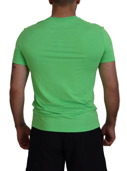 a man wearing a green shirt and black shorts