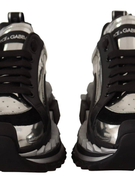 a pair of black and silver sneakers on a white background