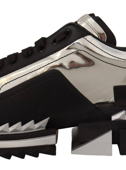 a pair of black and silver sneakers with spikes