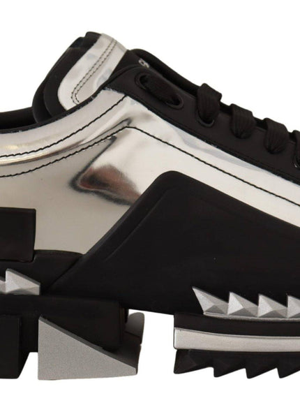 a pair of black and white sneakers with spikes