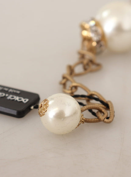 a necklace with a white pearl and a gold chain