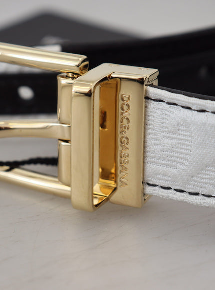 a white and black belt with a gold buckle