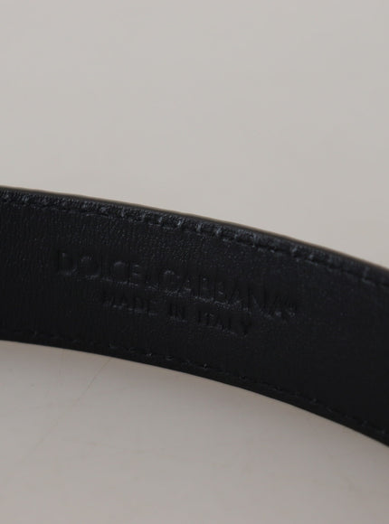 a close up of a black belt on a white surface