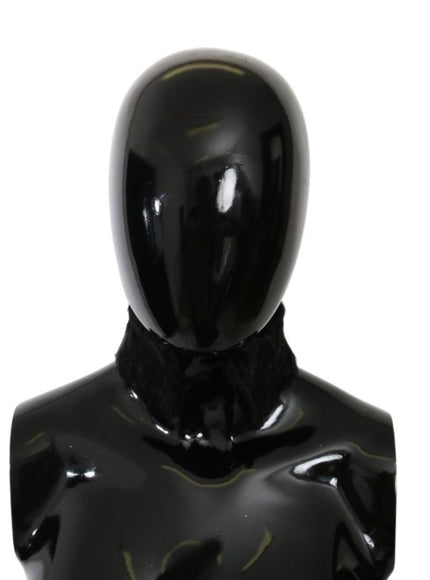 a black mannequin with a black tie around its neck