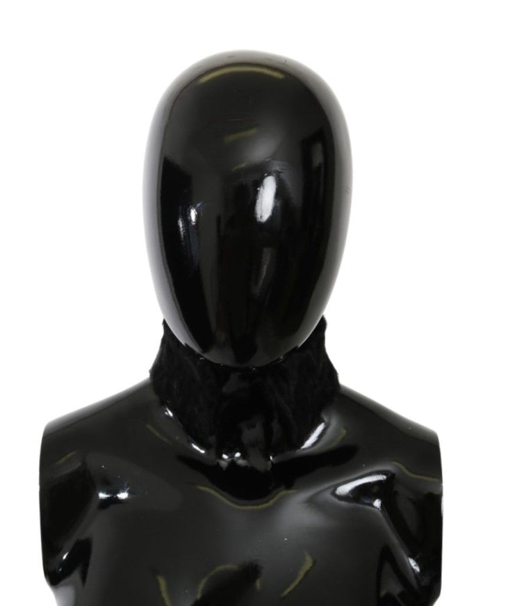 a black mannequin with a black tie around its neck