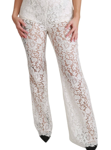 a woman wearing white lace pants and a bra