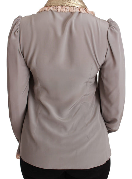 the back of a woman's blouse with a gold collar