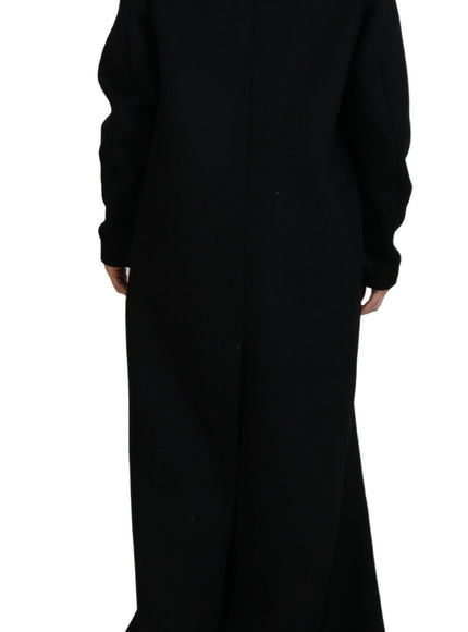 a woman in a long black coat