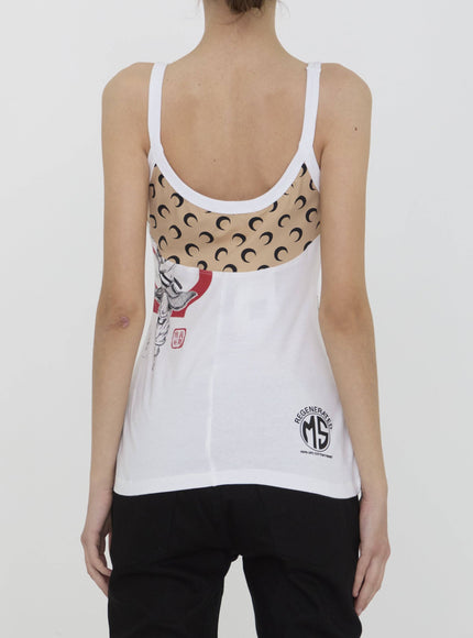 a woman wearing a white tank top with a graphic on it