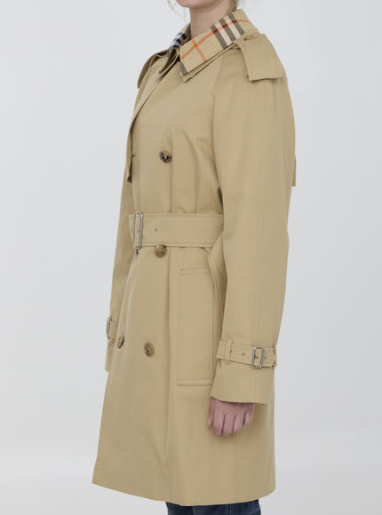 a woman in a trench coat posing for a picture