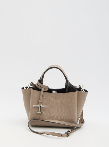 a beige purse with a cross on the front