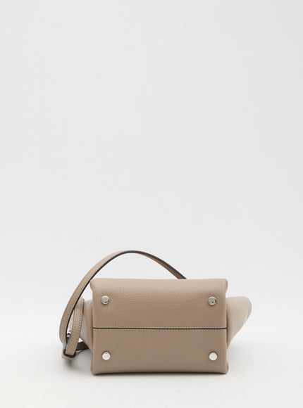 a beige purse with a strap on a white background