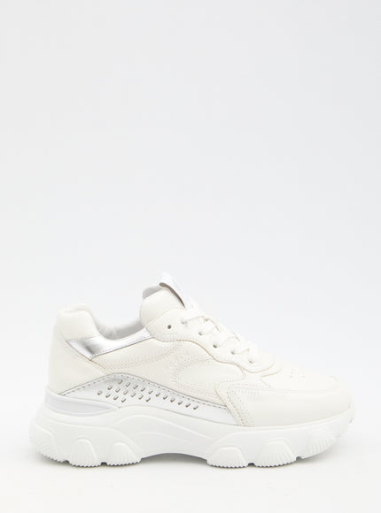 a woman's white sneaker with a white sole