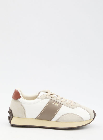 a white sneaker with a brown stripe on the side