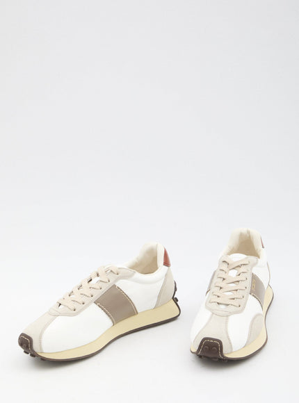 a pair of white and brown sneakers on a white surface