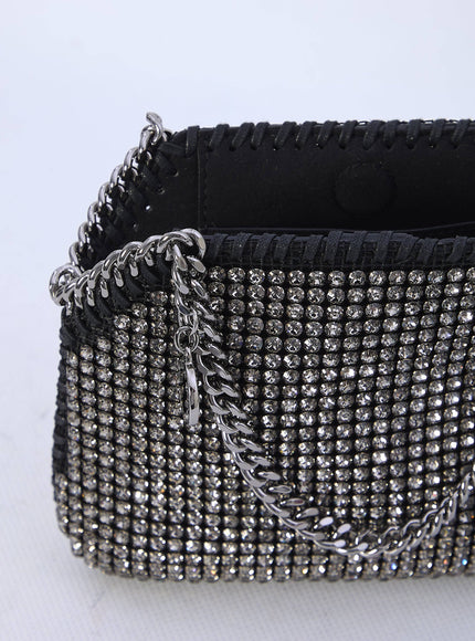 a black and silver purse on a white surface