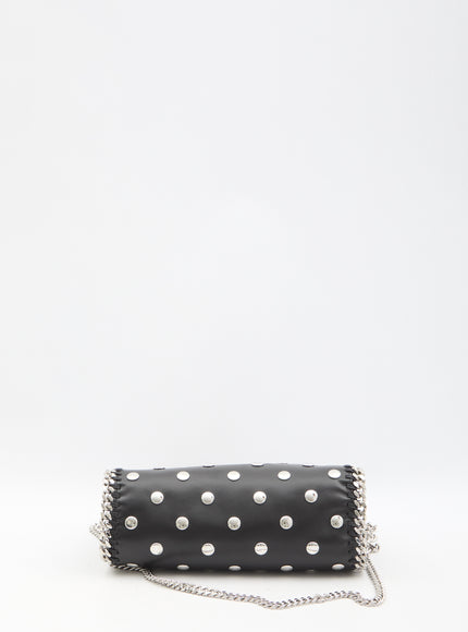 a black and white polka dot purse on a chain