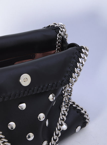 a black purse with silver rivets on it