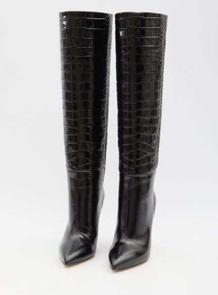 a pair of black high heel boots with crocodile skin