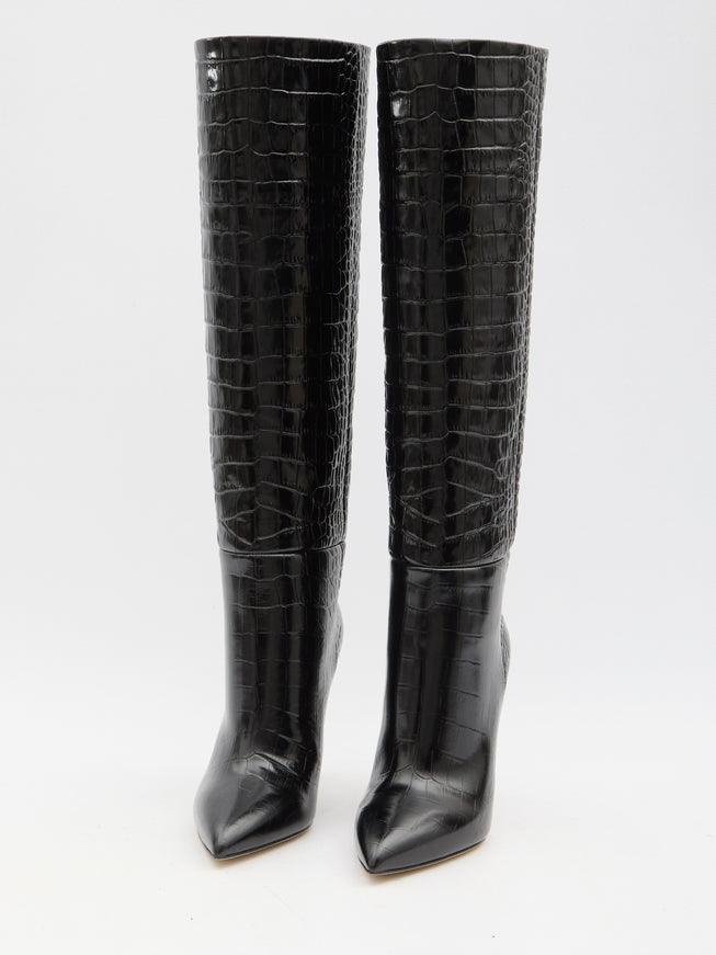 a pair of black high heel boots with crocodile skin