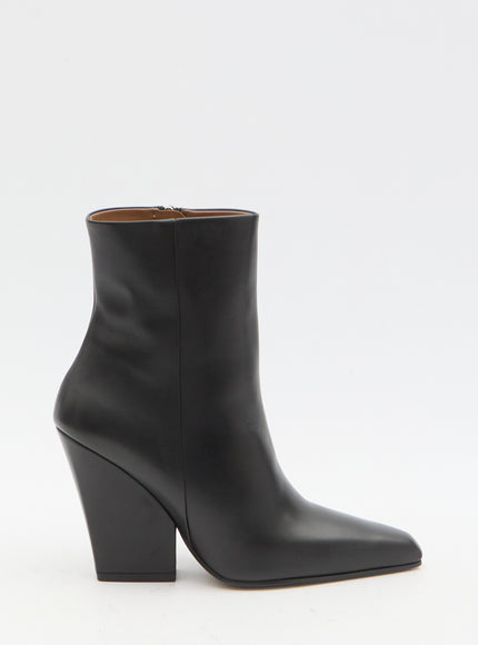 a pair of black leather ankle boots on a white background