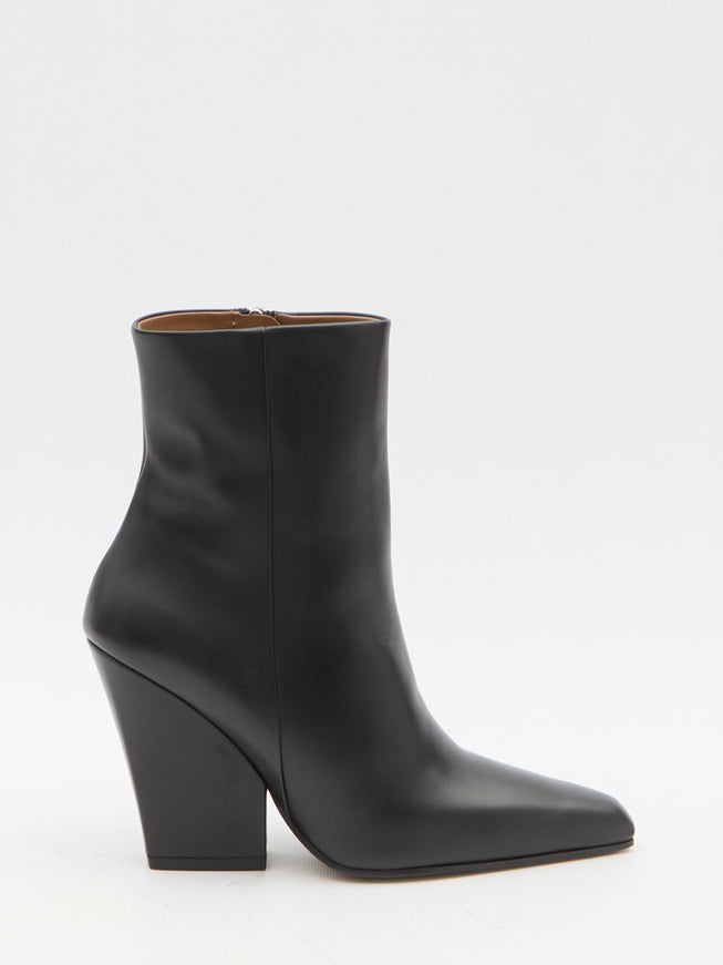 a pair of black leather ankle boots on a white background