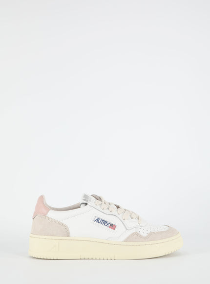 a white sneaker with a pink sole