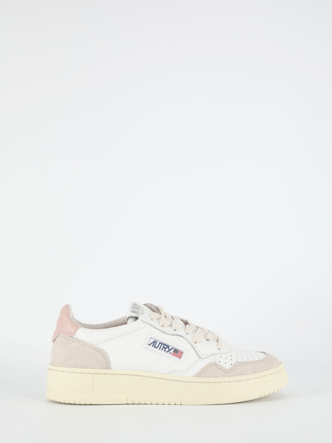 a white sneaker with a pink sole