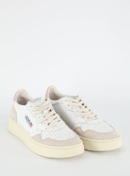 a pair of white sneakers on a white background