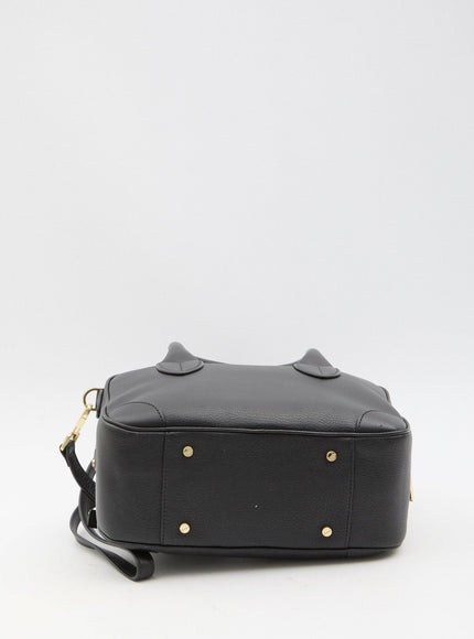 a black handbag with gold rivets on it