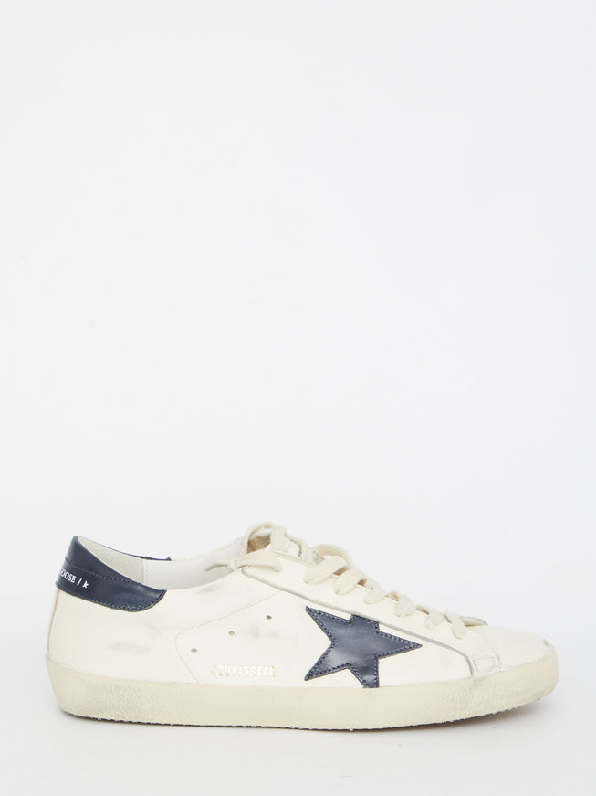 a white and blue sneaker with a star on the side