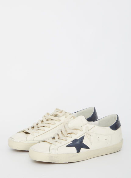 a white sneaker with a blue star on the side