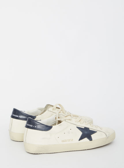 a white and blue sneaker with a star on the side